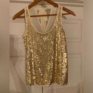 Sleeveless gold sequins top with sheer off white back. Sz S. Flares out slightly
